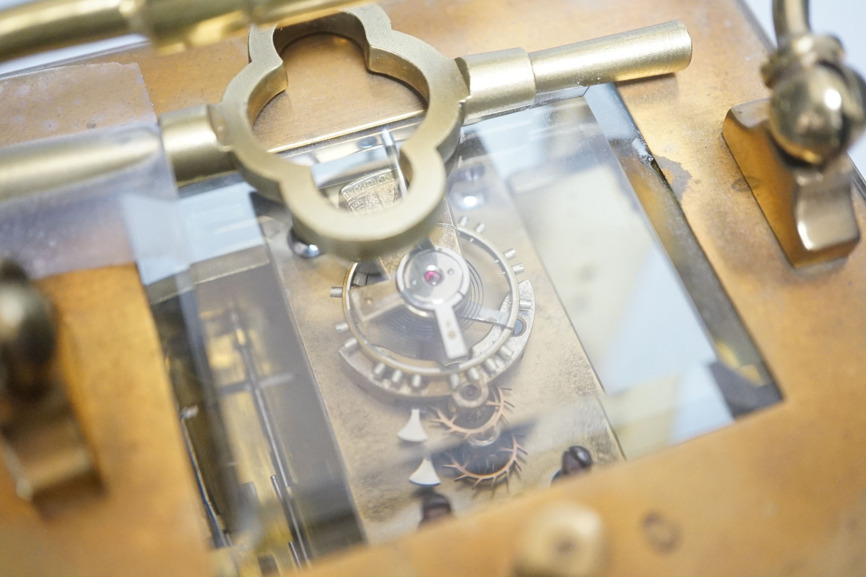 A brass repeating carriage clock, 13cm with key